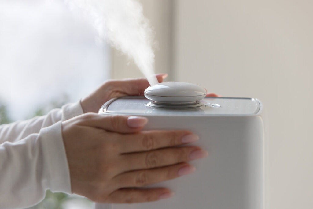 Woman Hands Touching And Using Humidifier